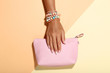 © 5second - Female hand with bracelets and handbag on colorful background