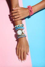 Female Hands With Bracelets On Colorful Background