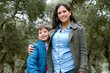 © Peruphotoart - Portrait of a happy son and mother posing looking at camera outdoors in winter
