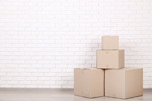 Cardboard Boxes On Brick Wall Background