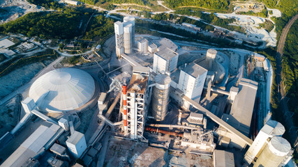 Aerial view of cement manufacturing plant. Concept of buildings at the factory, steel pipes, giants.