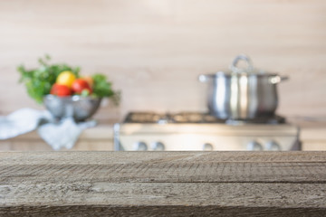 Wall Mural - Blurred background. Modern kitchen with empty wooden tabletop and space for you.