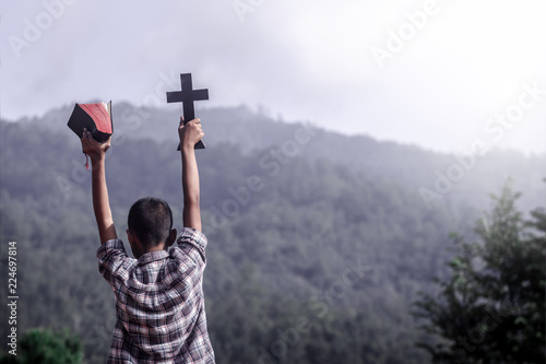 images Cross On Mountain Background https stock adobe com images boy holding bible and christian cross with mountain background young christian concept 224697814 start checkout 1 content id 224697814