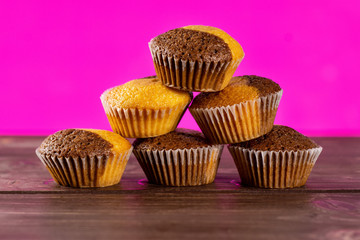 Set of six whole fresh baked marble muffin with pink in background