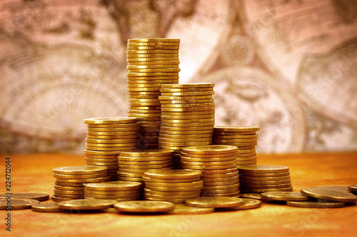 Fotografie, Tablou Capitalism concept : Coin stack on bank note and vintage map background