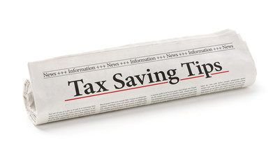 Rolled newspaper with the headline Tax saving tips