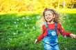 © bedya - Pretty little girl blowing bubbles in the park.