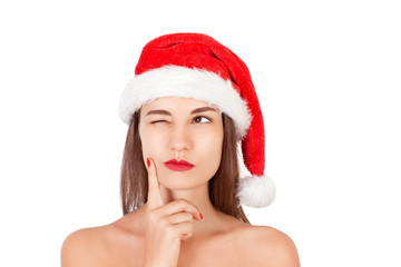  Girl in christmas hat dreaming about holidays. emotional woman in red santa claus hat isolated on white background. Happy Christmas and New Year holidays concept