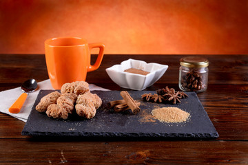 Breakfast with cinnamon biscuits and chocolate on a table 