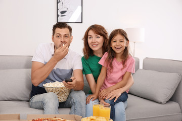 Wall Mural - Family watching TV with popcorn in room