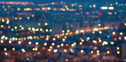 Wall Mural - city blurring lights abstract defocused circular bokeh on blue background with horizon at night