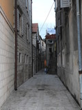Fototapeta Uliczki - Narrow street of seaside old town. 
