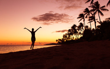 Canvas Print - Getting away from it all. Happy you woman walking on the beach at sunset. 