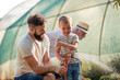 © ivanko80 - Father with his son working in the garden