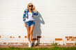 © Andrey_Arkusha - Beautiful sexy blonde woman dressed in a denim jacket and shorts