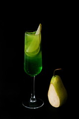 Wall Mural - green asian pear mojito cocktail in the glass on the dark background