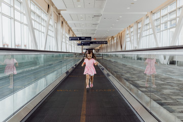 Little Girl Running on Airport Moving Sidewalk