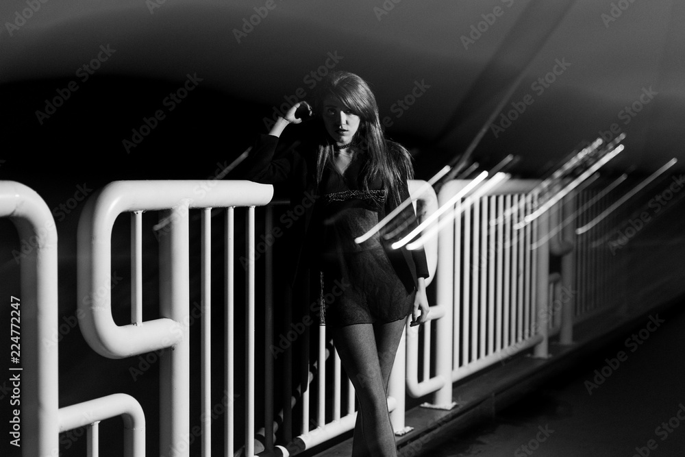 Resting On Railing Girl at night on the street, resting on a railing. Converted to black ...