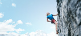 Fototapeta  - rock climbing. man rock climber climbing the challenging route on the rocky wall