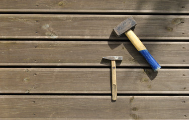 Two hammers with a wooden handle on the terrace. Building tools. Photo of two hammers on a sunny terrace. ledge hammer with wooden handle