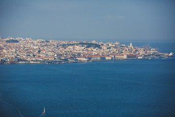 Wall Mural - Beautiful super wide-angle panoramic aerial view of Lisbon, Portugal with harbor and skyline scenery beyond the city, shot from belvedere observation deck of Cristo Rei