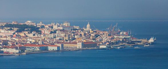 Wall Mural - Beautiful super wide-angle panoramic aerial view of Lisbon, Portugal with harbor and skyline scenery beyond the city, shot from belvedere observation deck of Cristo Rei