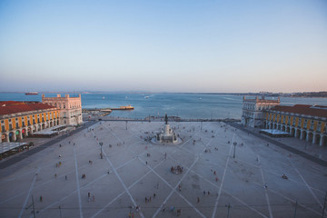 Wall Mural - Beautiful super wide-angle aerial view of Lisbon, Portugal with harbor and skyline scenery beyond the city, shot from belvedere observation deck Rua Augusta Triumphal Arch Viewpoint, Commerce Square