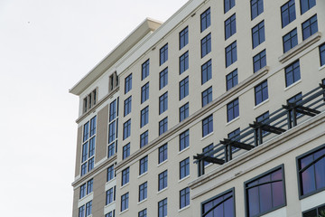 Exterior typical establishing shot stock photo of building facade during day time as apartment condo or hotel structure.