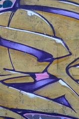 Wall Mural - Fragment of graffiti drawings. The old wall decorated with paint stains in the style of street art culture. Colored background texture in purple tones