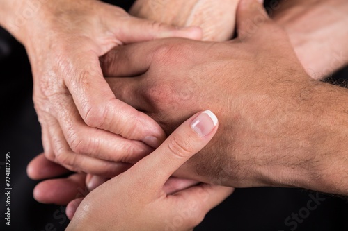 Cuadros en Lienzo Man and Woman Hands Holding an Old Woman's Hands