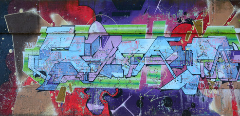 Wall Mural - Fragment of graffiti drawings. The old wall decorated with paint stains in the style of street art culture. Colored background texture in purple tones