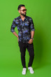 © Ranta Images - Young bearded Indian man against green background