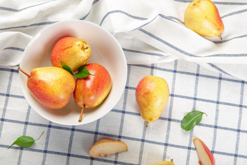 Poster - organic pears laying down on a lightly dotted kitchen cloth