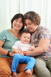 © DragonImages - Cheerful lesbian couple with their little baby boy