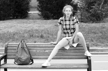 Cute Nerd Girl Sitting  In Provocative Pose On Bench