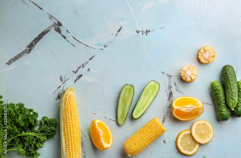 Flat lay composition with various vegetables and citrus fruits on light background