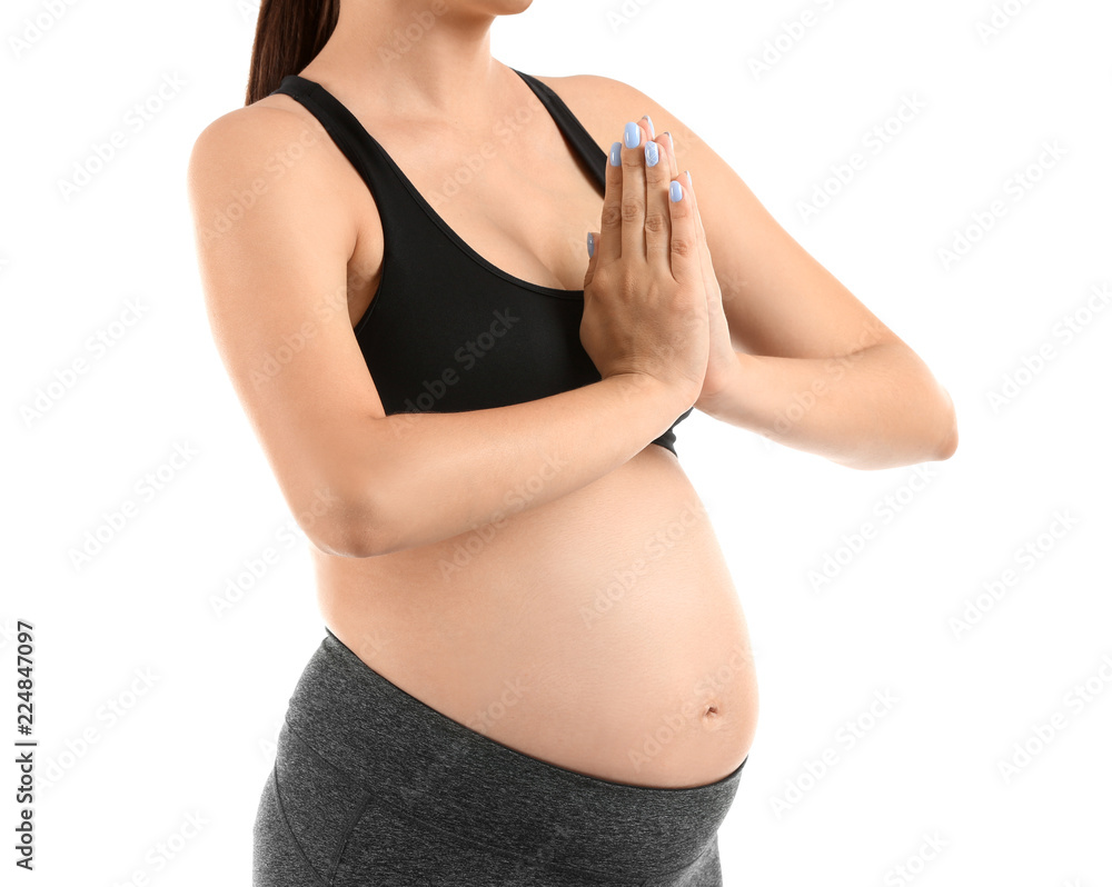 Young pregnant woman practicing yoga on white background