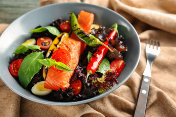 Tasty salmon with salad on plate