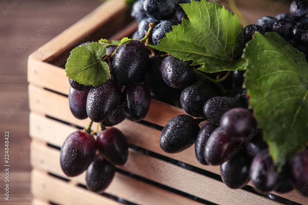 Ripe sweet grapes in wooden box