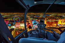Helicopter Interior On Las Vegas Buildings And Skyscrapers Of Downtown With Illuminated Casino Hotels At Night. Scenic Flight Above Vegas Skyline By Night In The Nevada United States Of America.