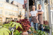 © LIGHTFIELD STUDIOS - smiling colleagues standing near flower shop and looking at camera