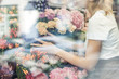 © LIGHTFIELD STUDIOS - cropped image of florist taking care of bouquets in flower shop