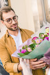 © LIGHTFIELD STUDIOS - florist giving beautiful bouquet of chrysanthemums to handsome customer near flower shop