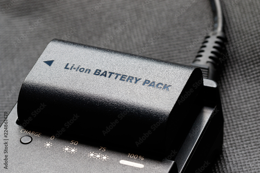 Rechargeable lithium-ion battery with charger - obrazy, fototapety, plakaty 