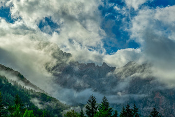 Wall Mural - Dramatic clouds in front of mountain