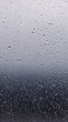 © Andrey - Rain drops at the window glass with blurred sky and forrest in the background with copy space for instagram stories size