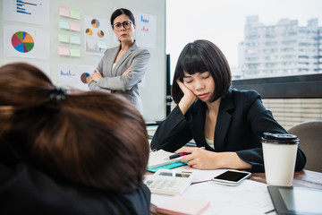 manager mad at  businesswomen sleeping in meeting