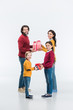© LIGHTFIELD STUDIOS - happy parents and kids presenting wrapped gifts to each other isolated on white