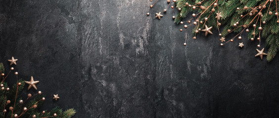 christmas decoration with fir branches on a dark shale backgroun
