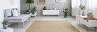 Panorama of a beige rug in the middle of a spacious living room interior with a modern, gray sofa and white, scandinavian furniture